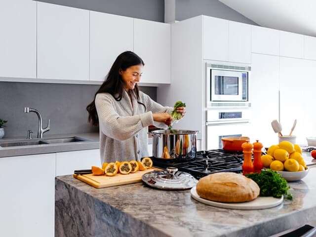 Hands chopping vegetables on a cutting board
