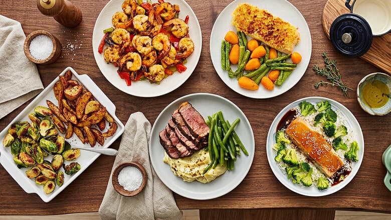 Suvie Kitchen Robot with roasted chicken, vegetables, and dessert