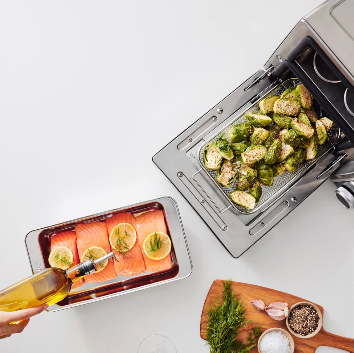 Suvie cooking salmon and Brussels sprouts in two zones at once