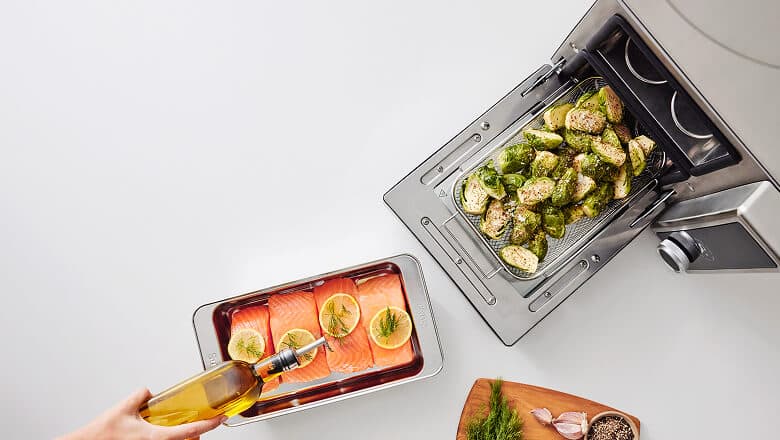 Suvie cooking salmon and Brussels sprouts in two zones at once